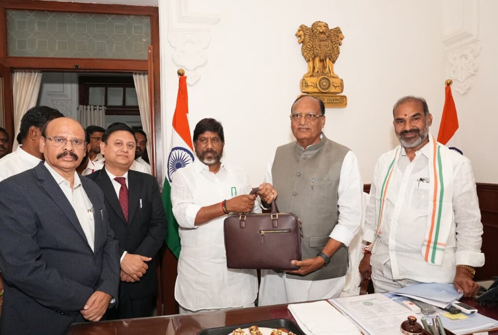 DY CM GIVING BUDGET PAPERS TO COUNCIL CHAIRMENT